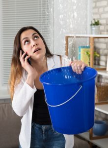 Woman Calling Plumber For Water Leakage At Home